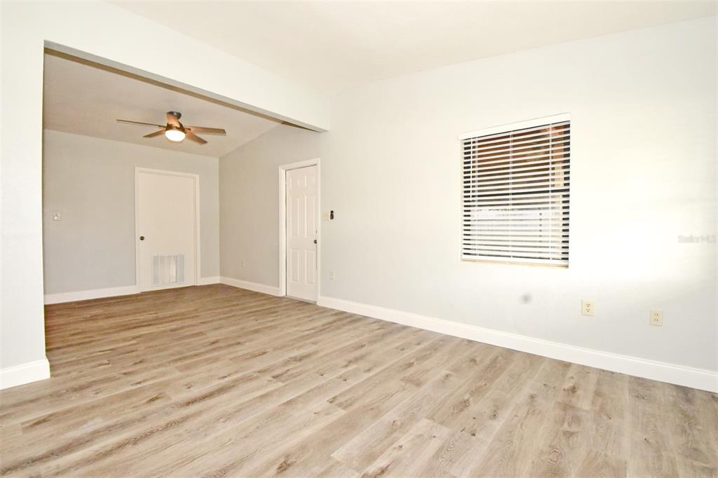 2148 Ridge Drive Winter Park, FL 32792 - Photo 18 of 33 a view of an empty room with wooden floor and a window