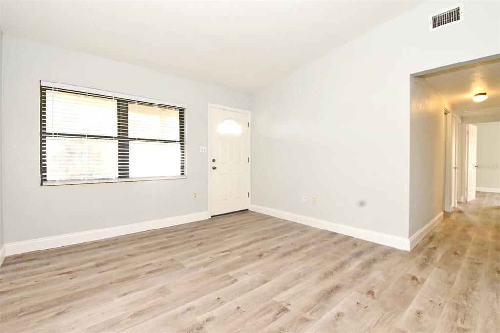 2148 Ridge Drive Winter Park, FL 32792 - Photo 20 of 33 an empty room with wooden floor and windows