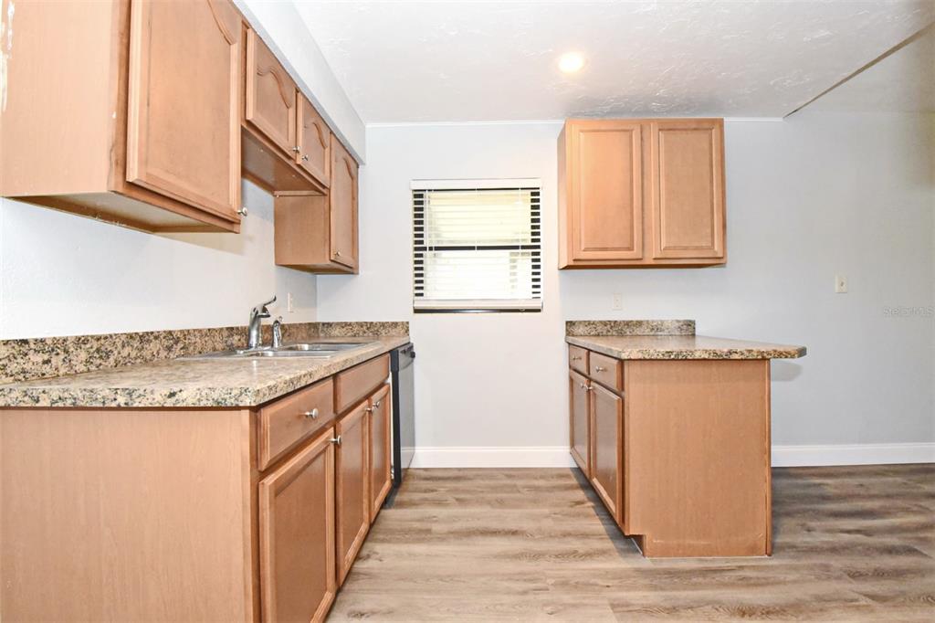 2148 Ridge Drive Winter Park, FL 32792 - Photo 3 of 33 a kitchen with granite countertop cabinets stainless steel appliances and a sink