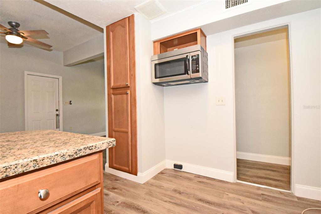 2148 Ridge Drive Winter Park, FL 32792 - Photo 4 of 33 a kitchen with stainless steel appliances granite countertop cabinets and wooden floor
