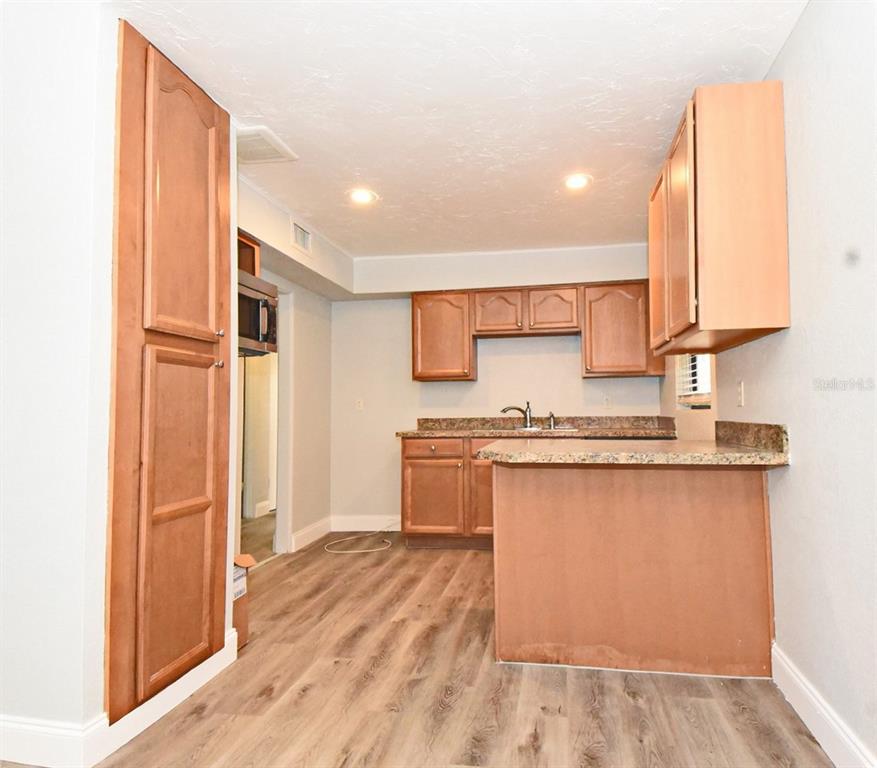 2148 Ridge Drive Winter Park, FL 32792 - Photo 5 of 33 a kitchen with stainless steel appliances granite countertop a stove a sink and a refrigerator