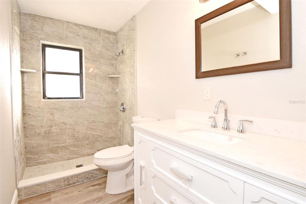 2148 Ridge Drive Winter Park, FL 32792 - Photo 6 of 33 a bathroom with a toilet sink vanity and mirror