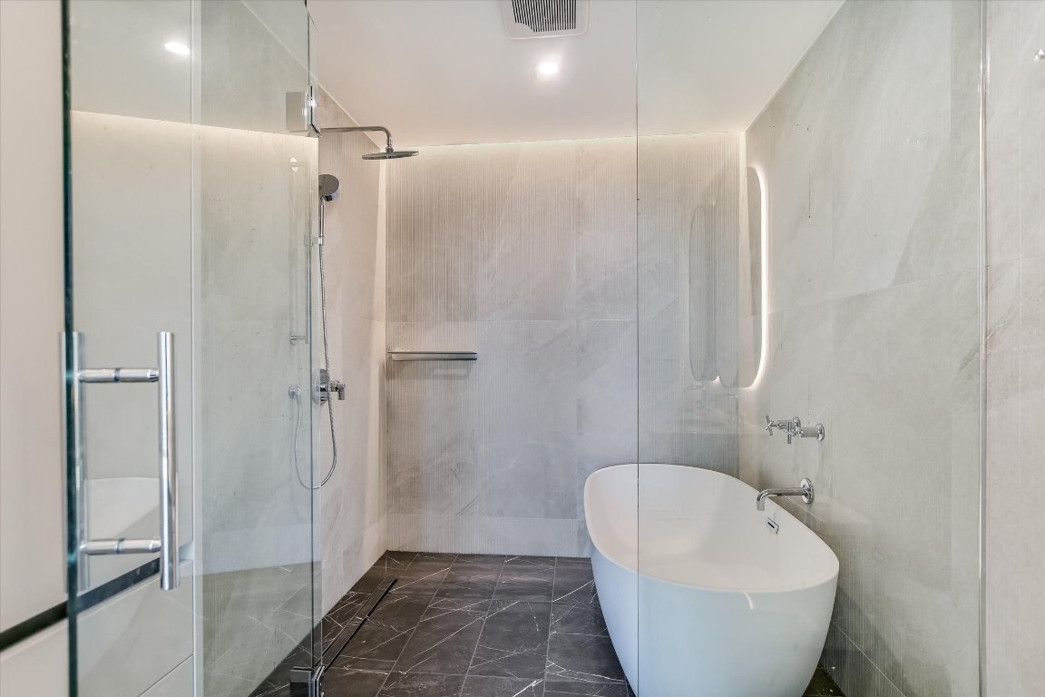 610 Davis Street, Unit 4602 Austin, TX 78701 - Photo 11 of 35 a bathroom with a bathtub and shower