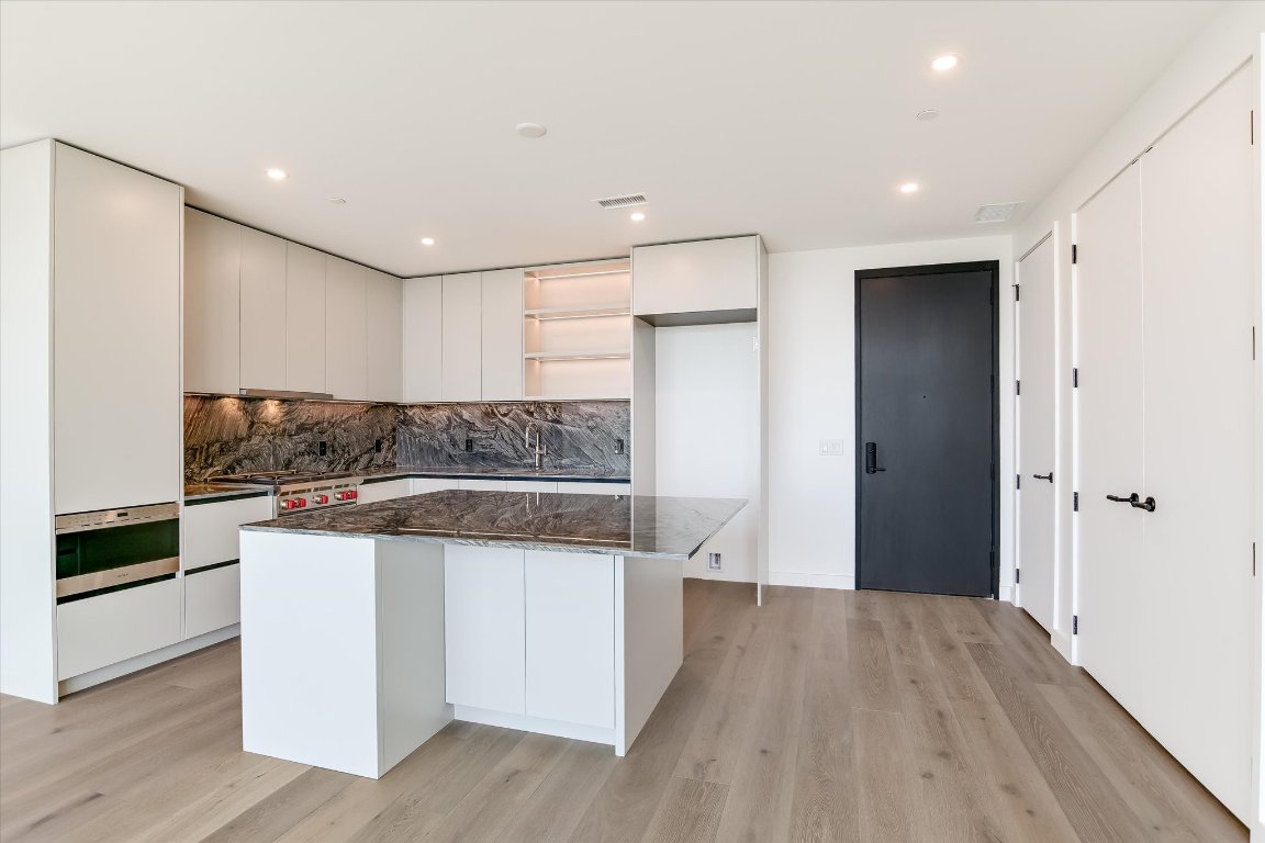 610 Davis Street, Unit 4602 Austin, TX 78701 - Photo 3 of 35 a kitchen with a refrigerator and a stove top oven