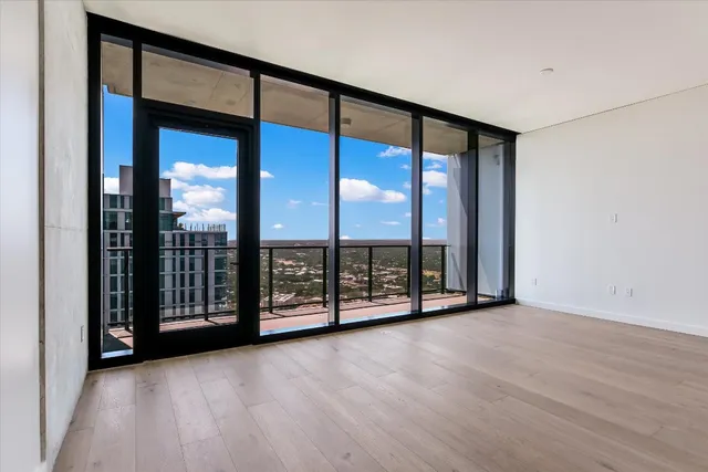 a view of a room with wooden floor