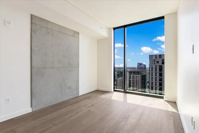 a bathroom with a granite countertop toilet a sink and a mirror