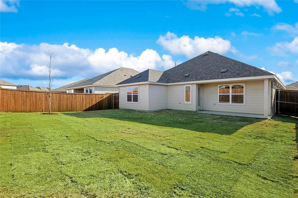 1759 Gleasondale Place Forney, TX 75126 - Photo 19 of 25 Back of property with roof with shingles and a fenced backyard