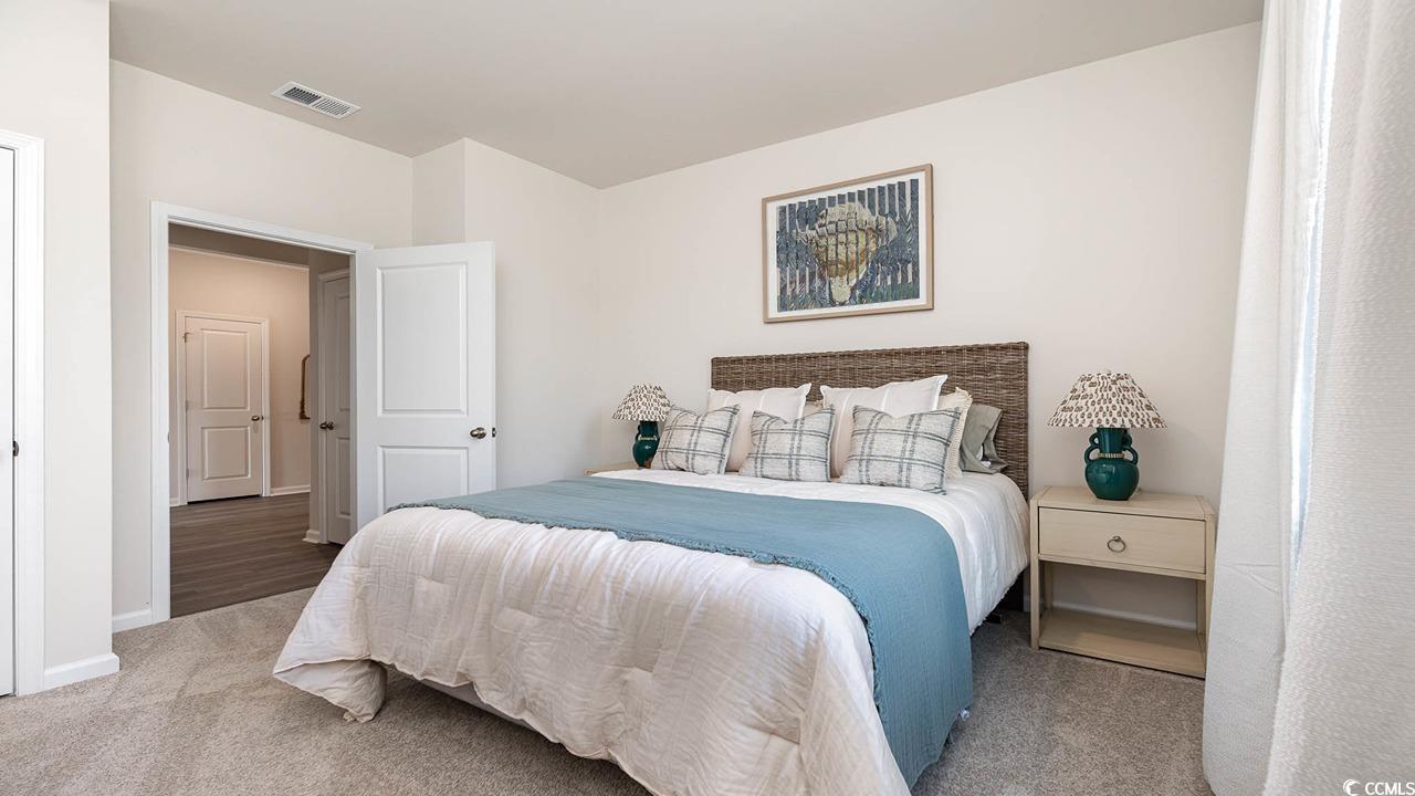 7383 Meadow Walk Loop Loris, SC 29569 - Photo 20 of 29 Carpeted bedroom featuring visible vents and baseboards