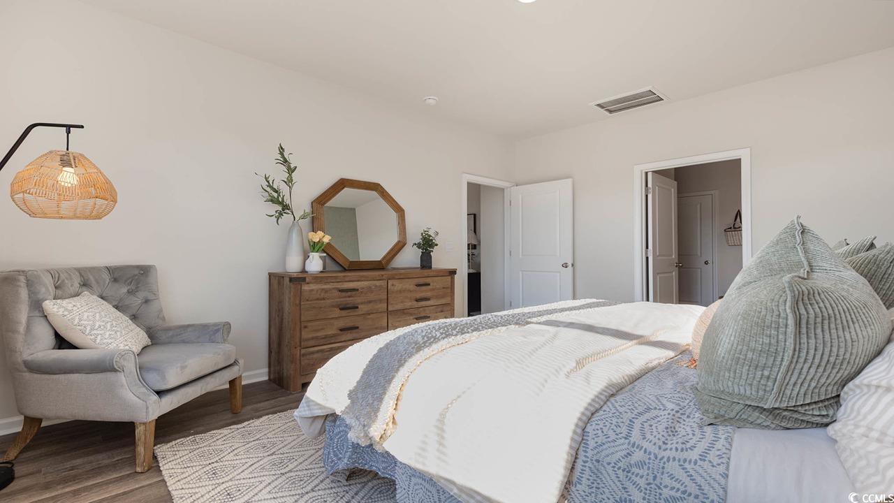 7383 Meadow Walk Loop Loris, SC 29569 - Photo 22 of 29 Bedroom featuring visible vents, baseboards, and wood finished floors