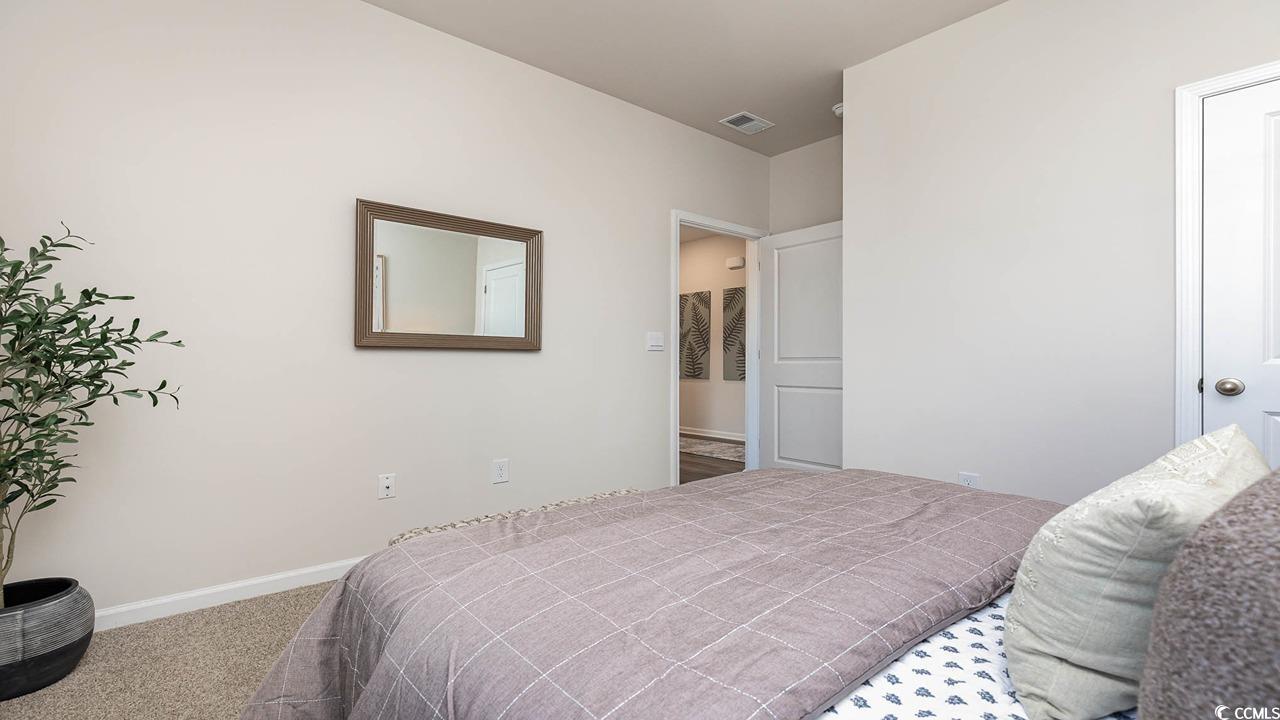 7383 Meadow Walk Loop Loris, SC 29569 - Photo 26 of 29 Carpeted bedroom featuring visible vents and baseboards