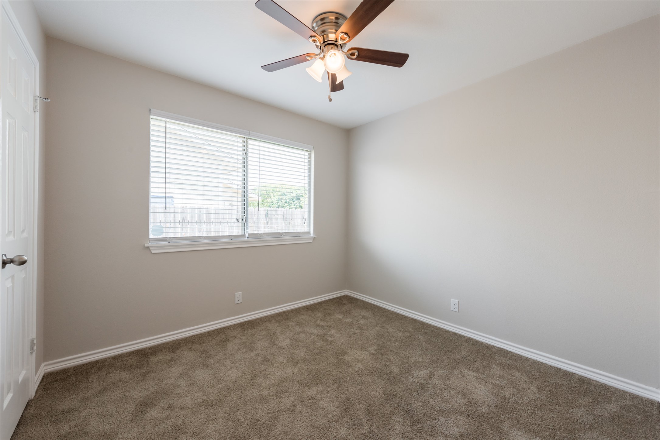 5703 Teri Road Austin, TX 78744 - Photo 13 of 16 an empty room with a window and a fan