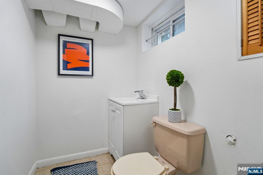 26 Rutgers Place Bloomfield, NJ 07003 - Photo 28 of 38 a bathroom with a toilet sink and mirror