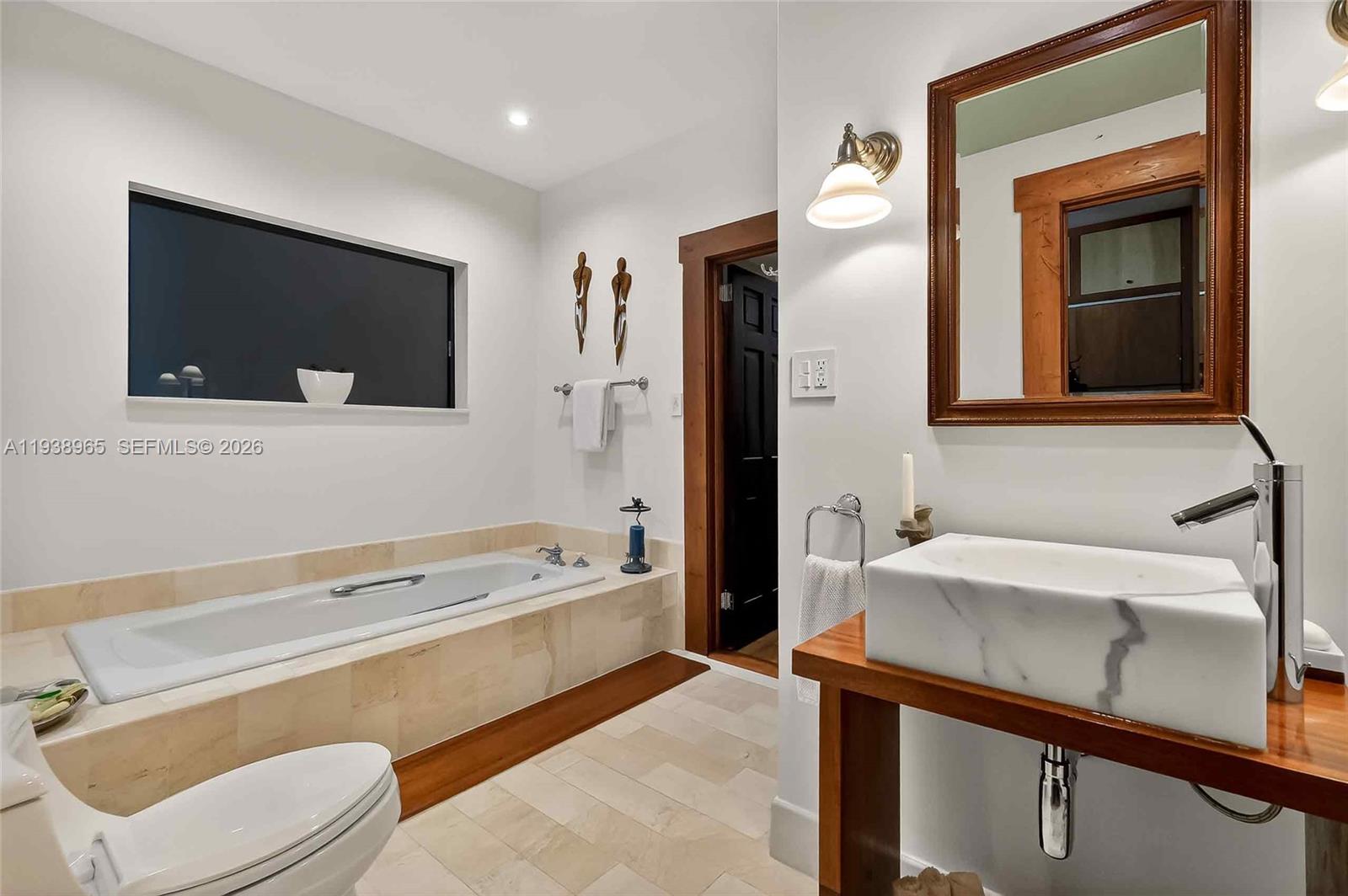 452 Southwest 21st Road Miami, FL 33129 - Photo 21 of 51 a bathroom with a sink a toilet and mirror