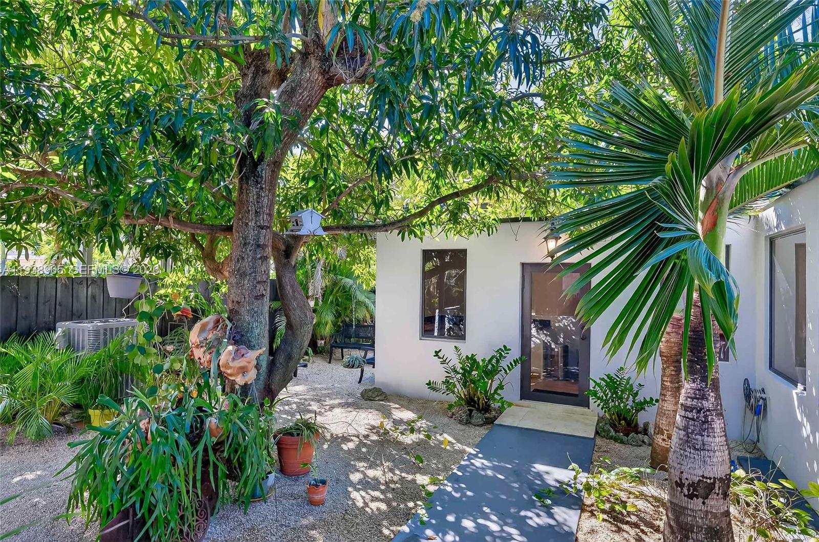 452 Southwest 21st Road Miami, FL 33129 - Photo 29 of 51 a backyard of a house with a garden and outdoor seating