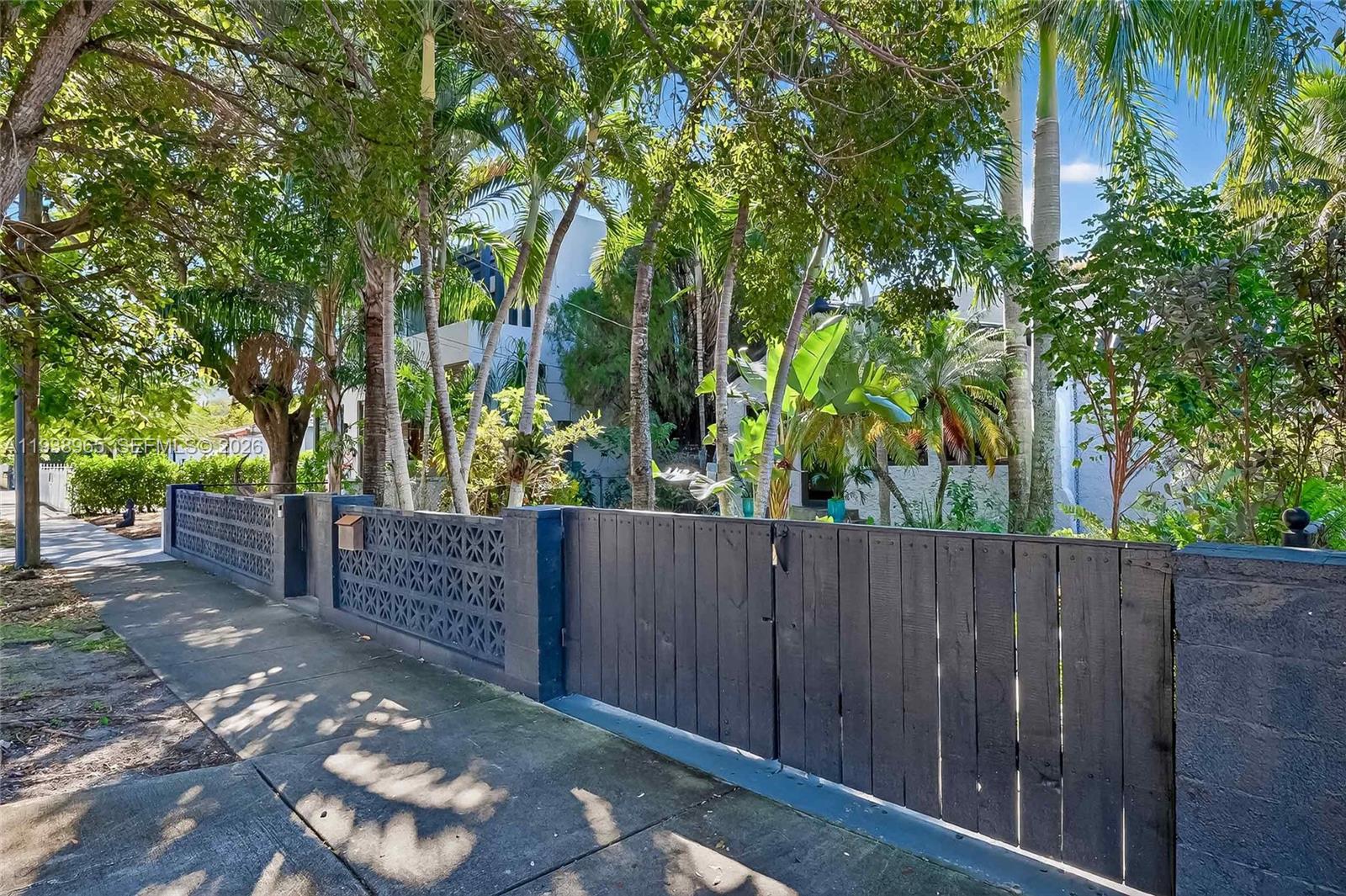 452 Southwest 21st Road Miami, FL 33129 - Photo 42 of 51 a view of a wooden fence and trees
