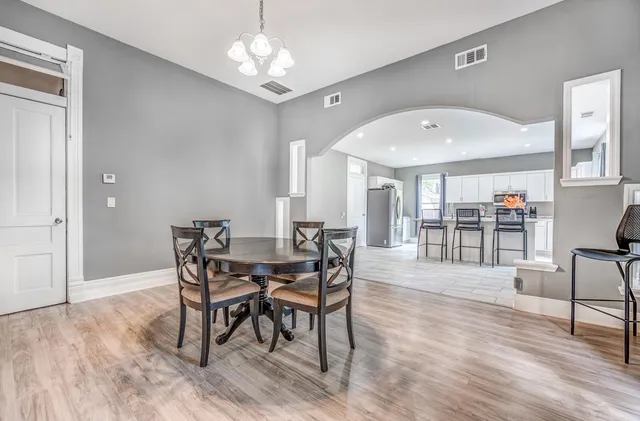 a view of a dining room with furniture and wooden floor