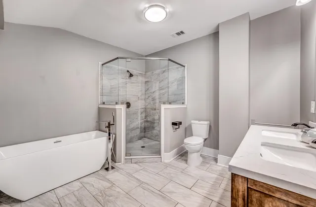 a bathroom with a sink toilet and shower