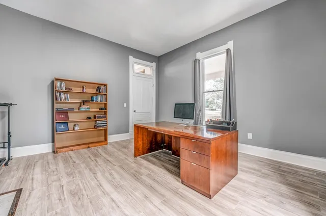 a view of a room with wooden floor and cabinet
