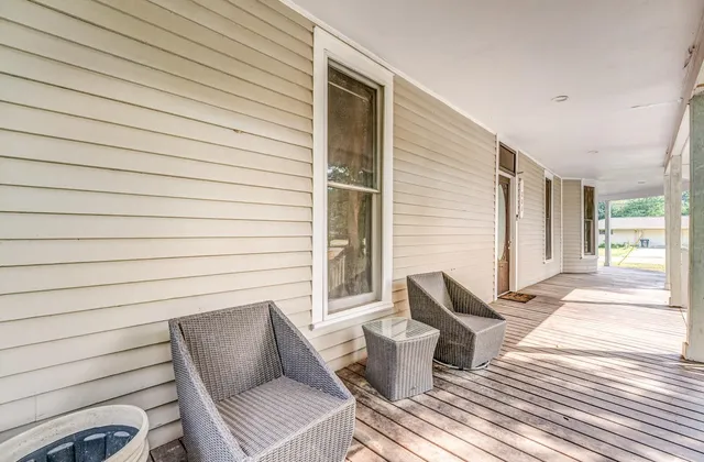 a view of a patio with chair and wooden floor