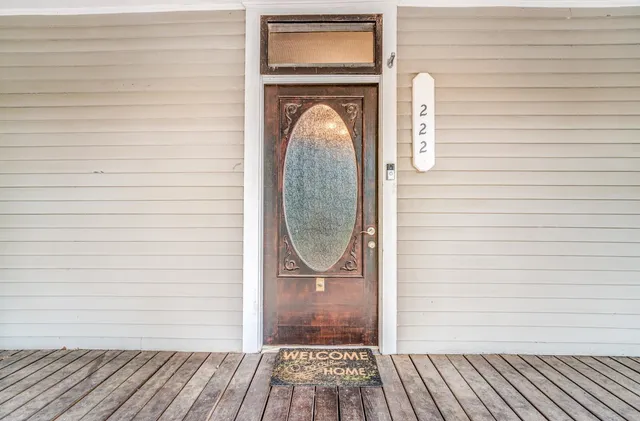 a view of a door of a house with wooden floor