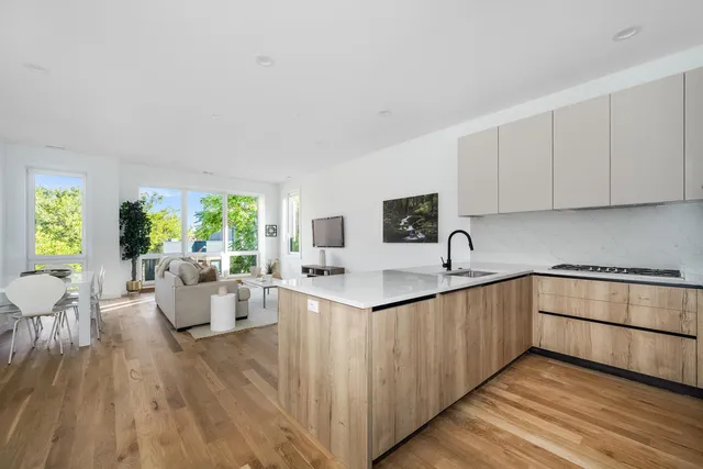 a kitchen with counter top space and living room