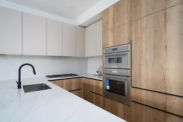 a kitchen with granite countertop a stove top oven and sink