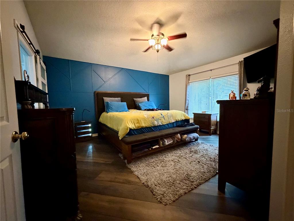 4303 Orange Ridge Court Valrico, FL 33596 - Photo 29 of 40 a bedroom with a bed and flat screen tv