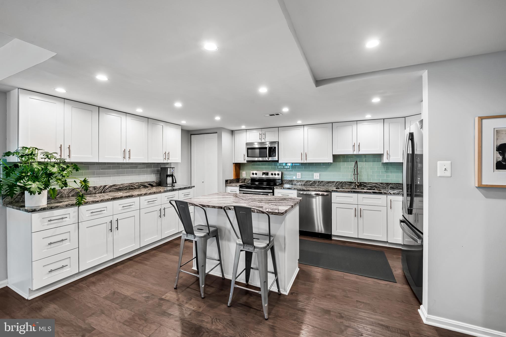 1040 Deer Ridge Drive, Unit 200 Baltimore, MD 21210 - Photo 14 of 38 a kitchen with white cabinets stainless steel appliances and center island