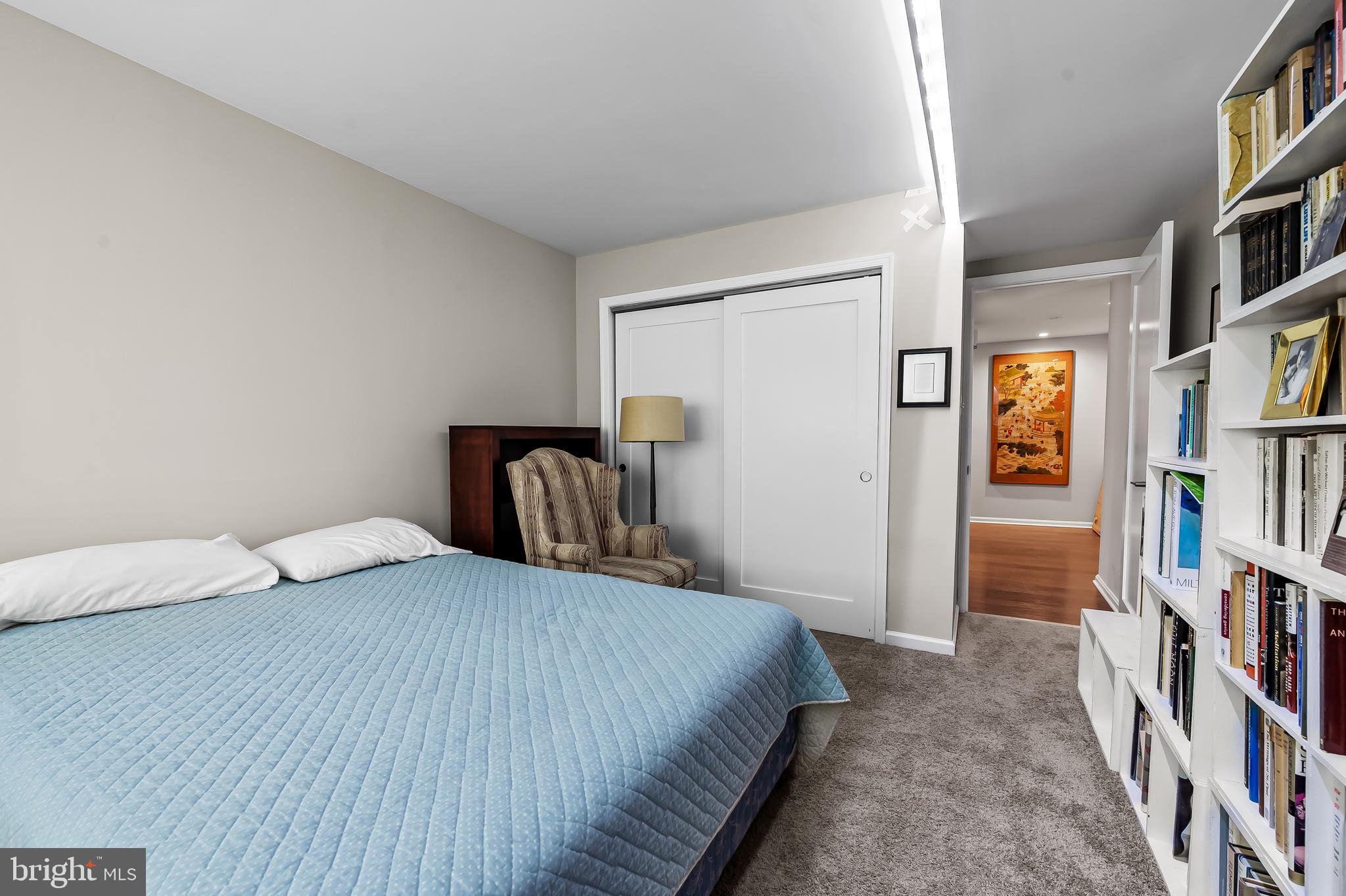 1040 Deer Ridge Drive, Unit 200 Baltimore, MD 21210 - Photo 29 of 38 a bedroom with a bed and a book shelf