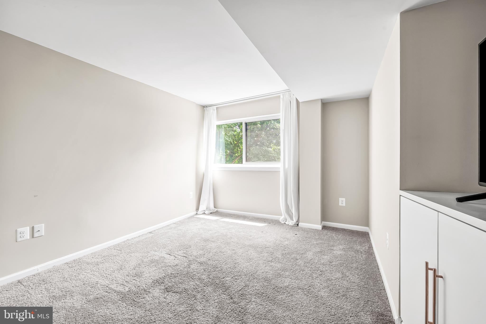 1040 Deer Ridge Drive, Unit 200 Baltimore, MD 21210 - Photo 32 of 38 a view of an empty room with a window