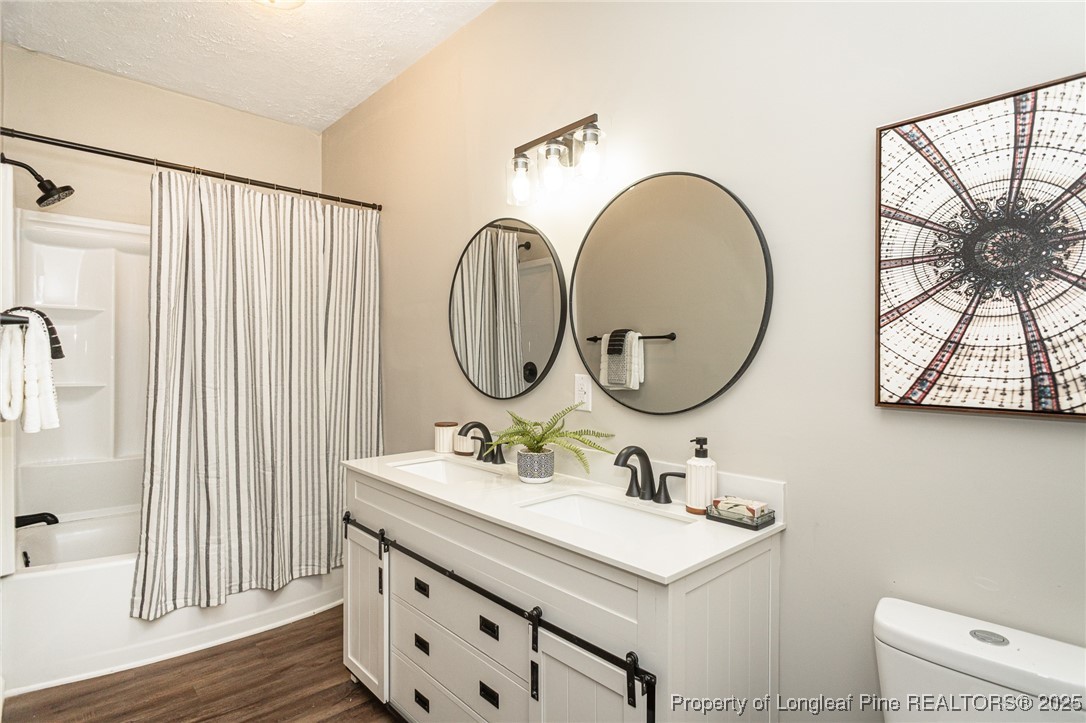 102 North 17th Street Erwin, NC 28339 - Photo 12 of 32 a bathroom with a sink and a mirror