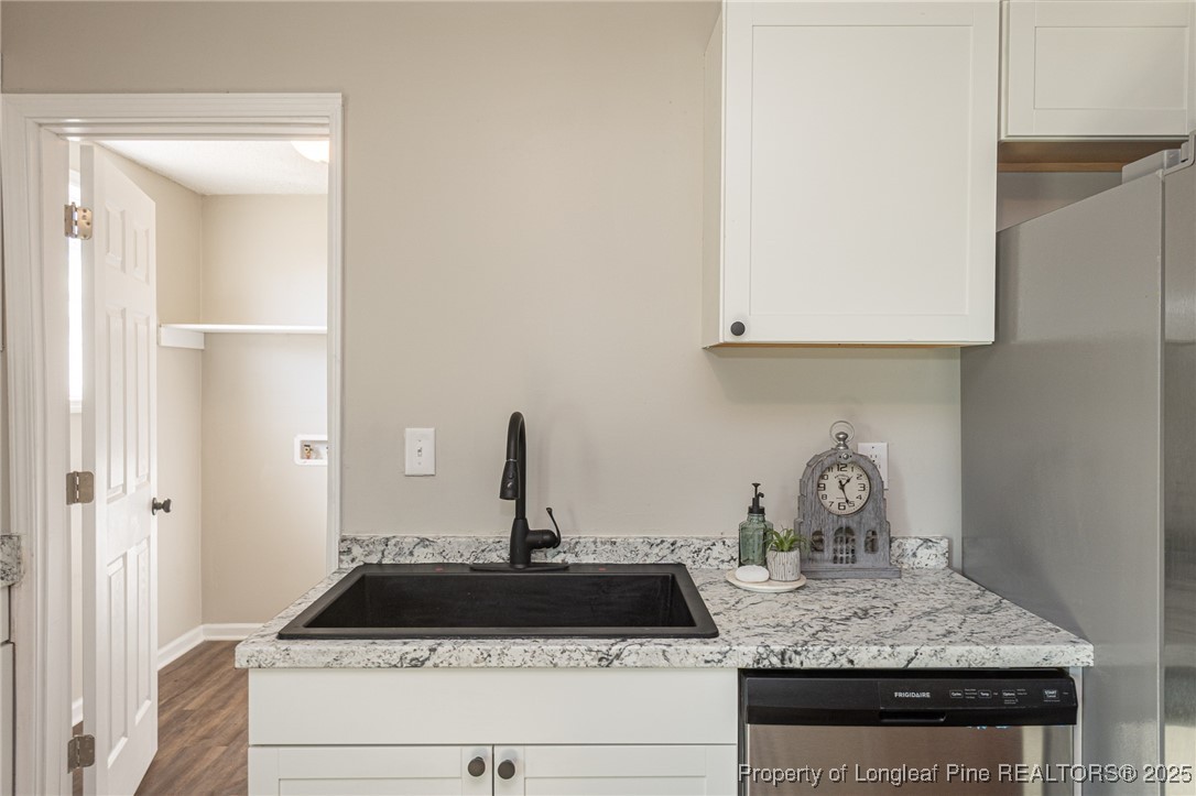102 North 17th Street Erwin, NC 28339 - Photo 13 of 32 a kitchen with a stove and cabinets