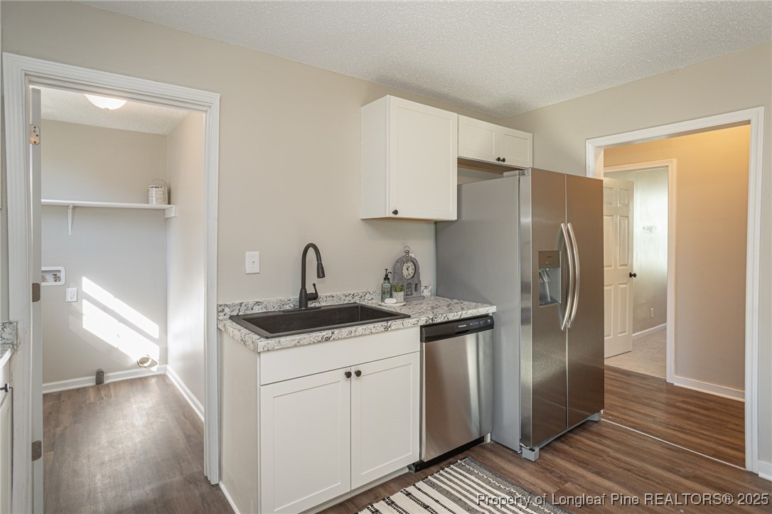 102 North 17th Street Erwin, NC 28339 - Photo 21 of 32 a kitchen with stainless steel appliances granite countertop a refrigerator and a sink