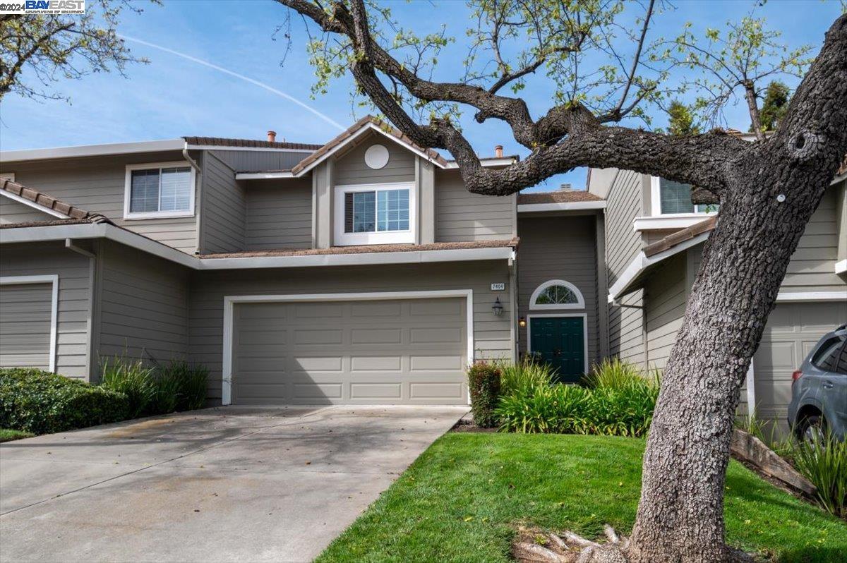 a front view of a house with a garden and garage