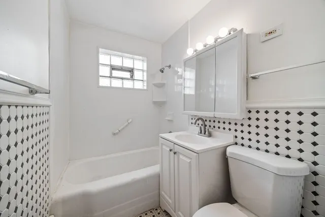 a bathroom with a toilet a sink and a bathtub