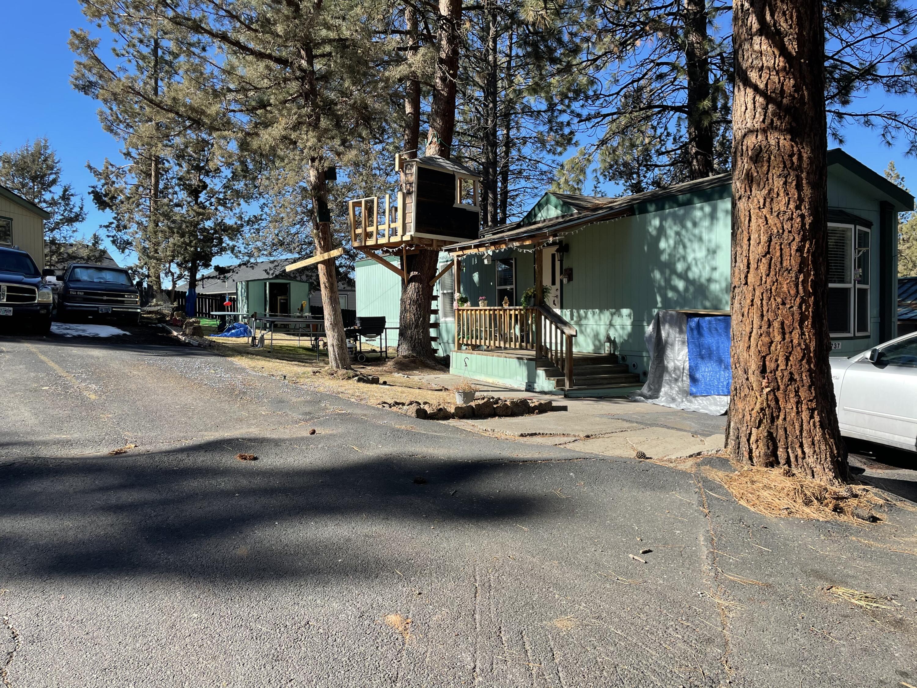 60901 Brosterhous Road, Unit 737 Bend, OR 97702 - Photo 1 of 17 a view of street with parked cars