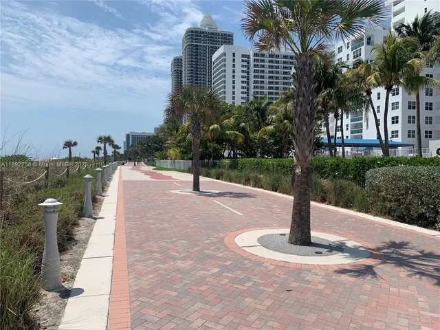 a sign board with water fountain in front of it
