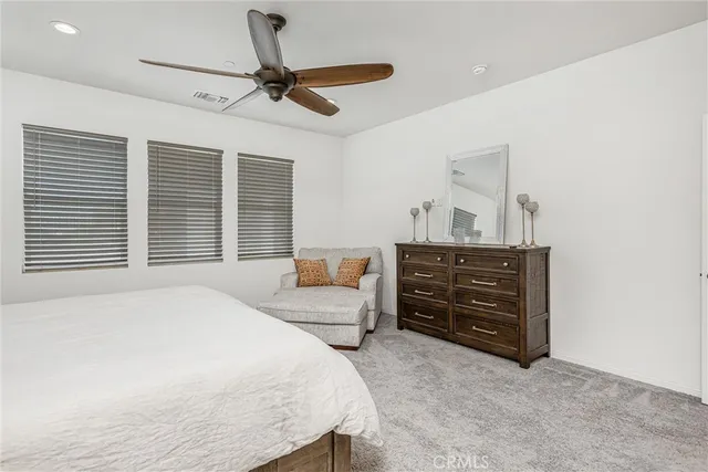 a bedroom with a bed dresser and a window