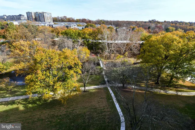 a view of residential houses with outdoor space and trees