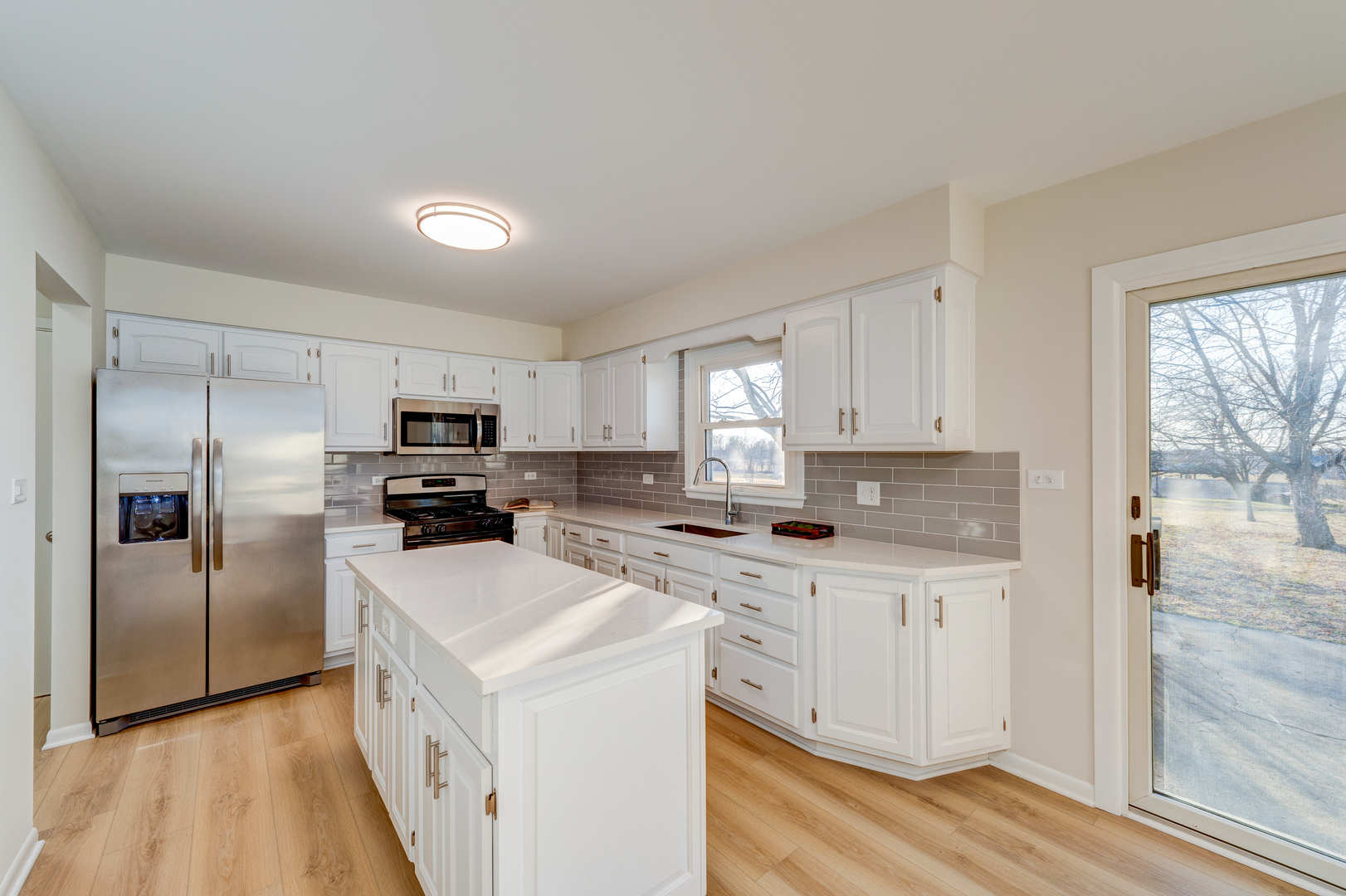 2S746 South Raddant Road Batavia, IL 60510 - Photo 9 of 27 a kitchen with a sink a counter top space stainless steel appliances and cabinets