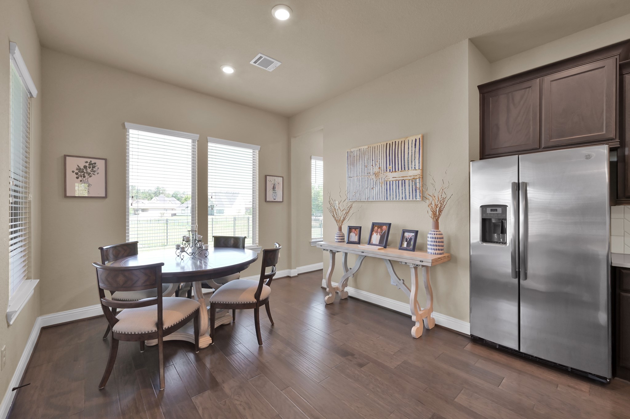 4906 Tres Lagos Drive Spring, TX 77389 - Photo 14 of 32 a kitchen with stainless steel appliances wooden floor and dining table