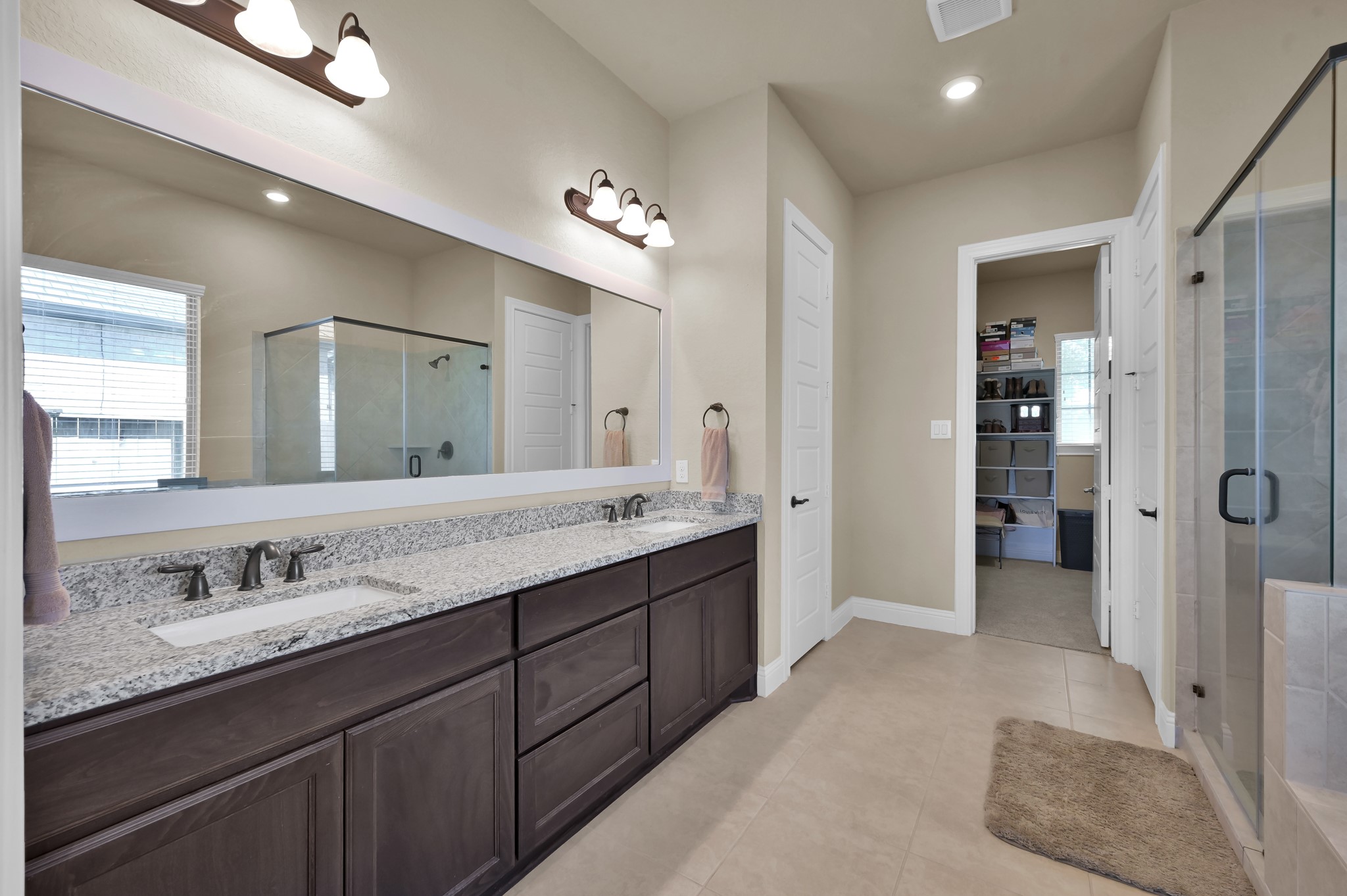 4906 Tres Lagos Drive Spring, TX 77389 - Photo 16 of 32 a spacious bathroom with a granite countertop sink mirror and shower