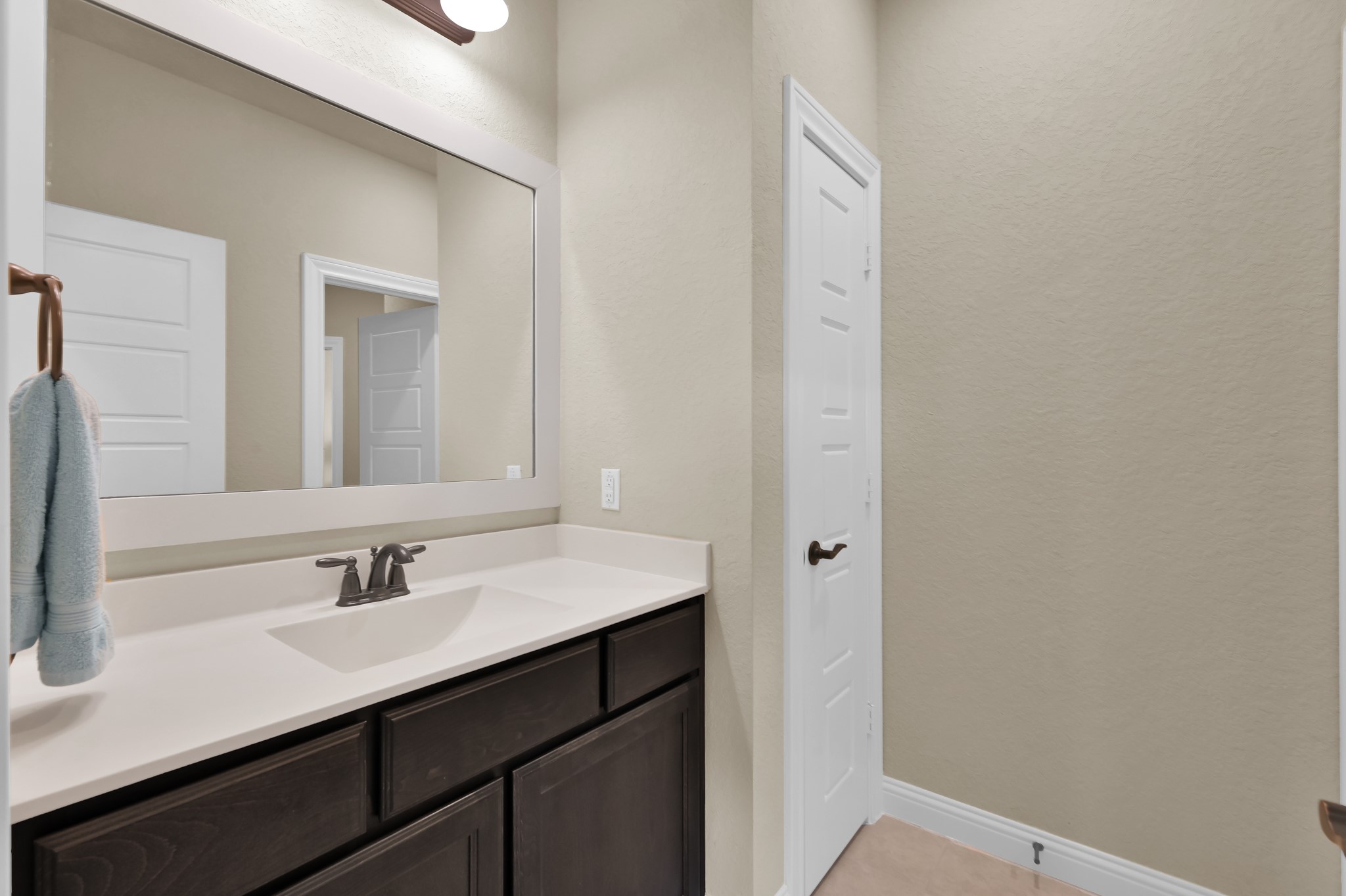 4906 Tres Lagos Drive Spring, TX 77389 - Photo 22 of 32 a bathroom with a sink and a mirror