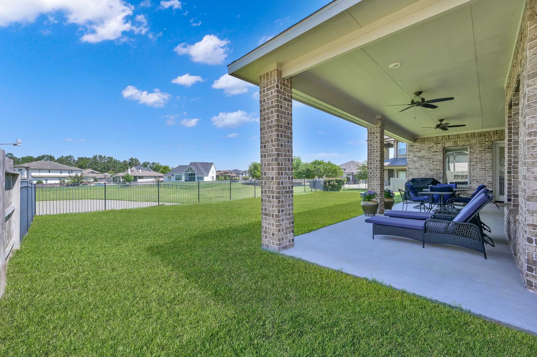 4906 Tres Lagos Drive Spring, TX 77389 - Photo 25 of 32 a view of a garden with lawn chairs and a yard