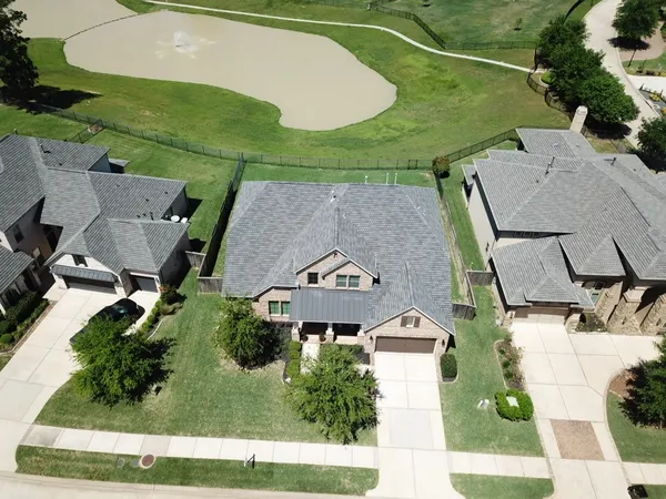 a front view of a house with a garden and yard