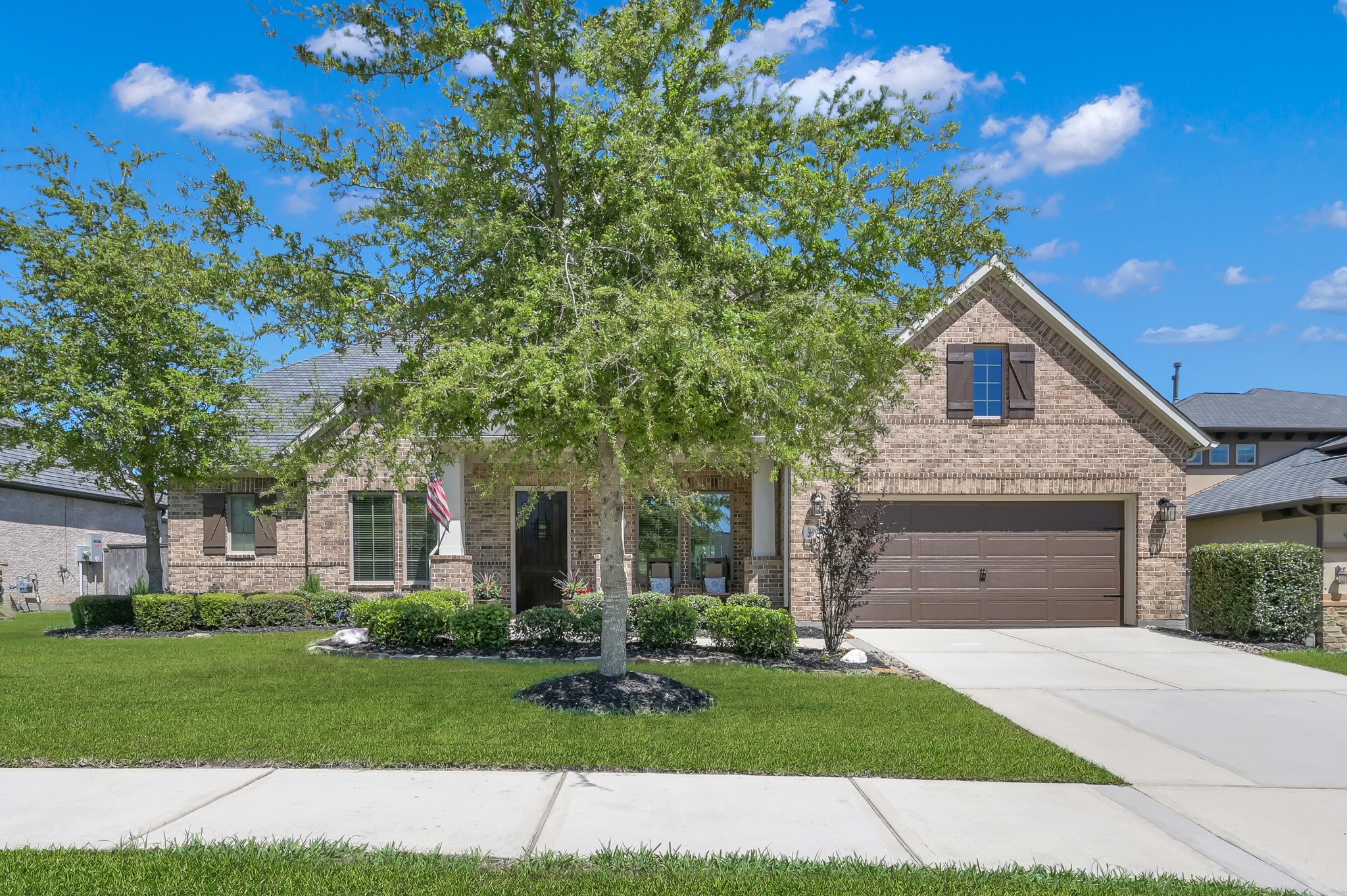 4906 Tres Lagos Drive Spring, TX 77389 - Photo 30 of 32 a front view of a house with a garden and yard