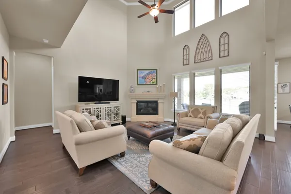 a living room with furniture a flat screen tv and a fireplace