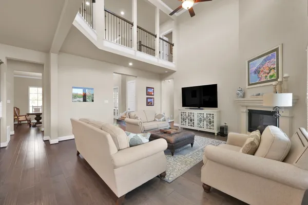 a large kitchen with cabinets a sink a counter space and a view of living room