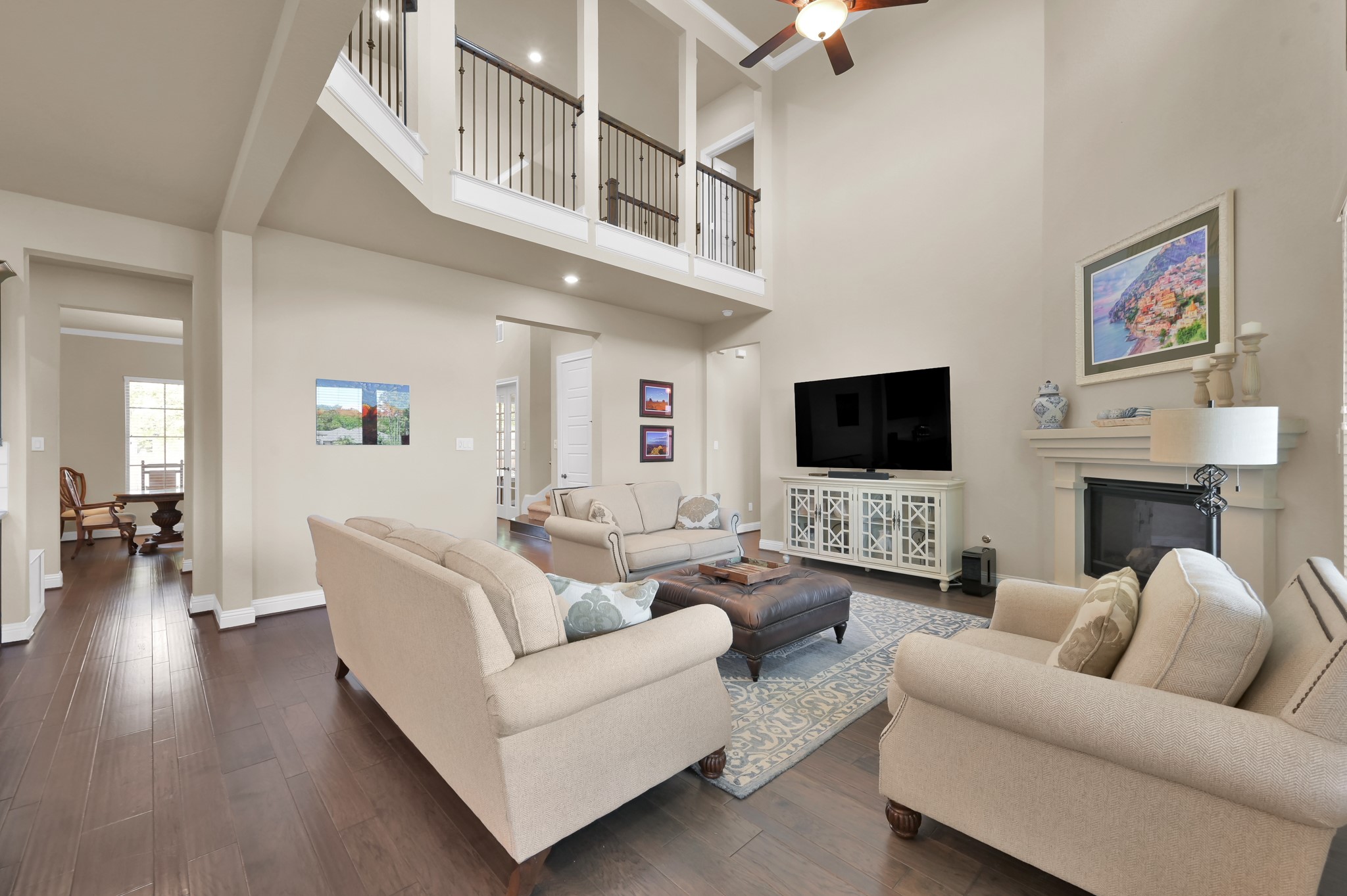 4906 Tres Lagos Drive Spring, TX 77389 - Photo 10 of 32 a living room with furniture a flat screen tv and a fireplace