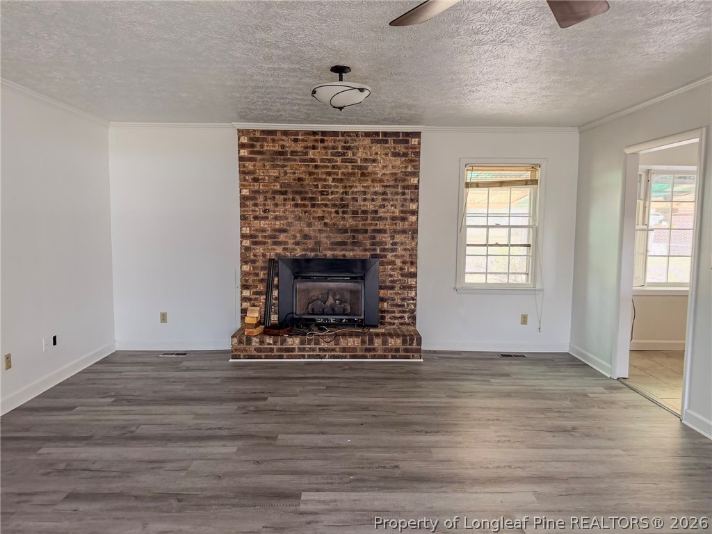 575 Veterans Road St. Pauls, NC 28384 - Photo 3 of 27 a view of an empty room with wooden floor and a window
